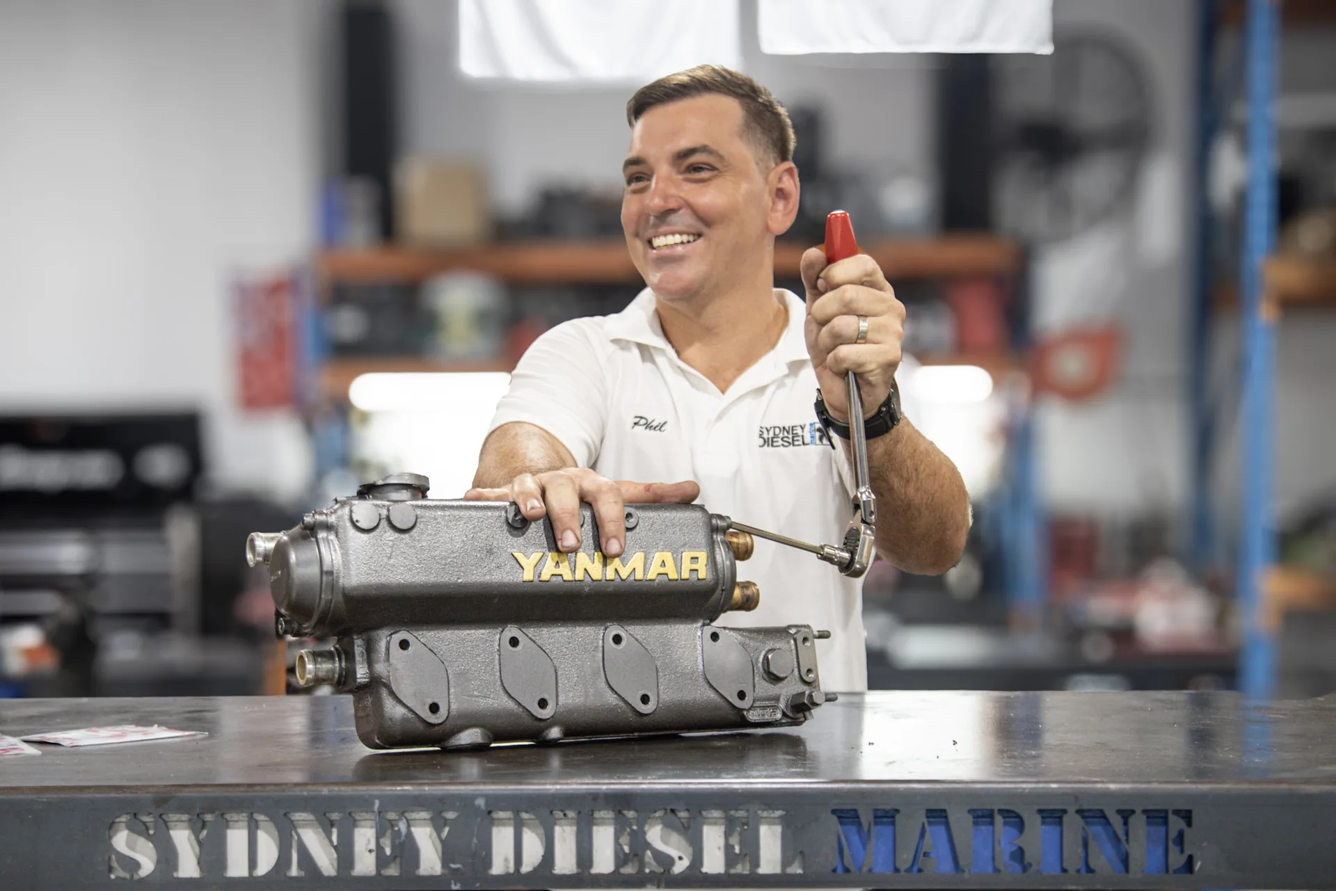 Phil Lulic at the Sydney Diesel Marine workbench with a Yanmar marine diesel