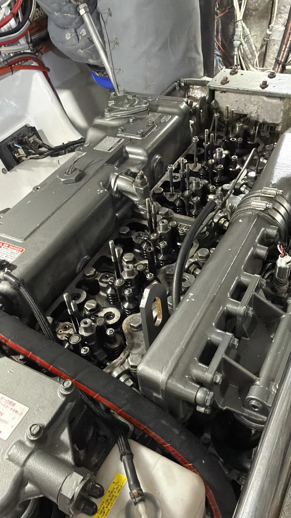 A Yanmar marine diesel with the rocker cover off, valve train exposed during a rebuild