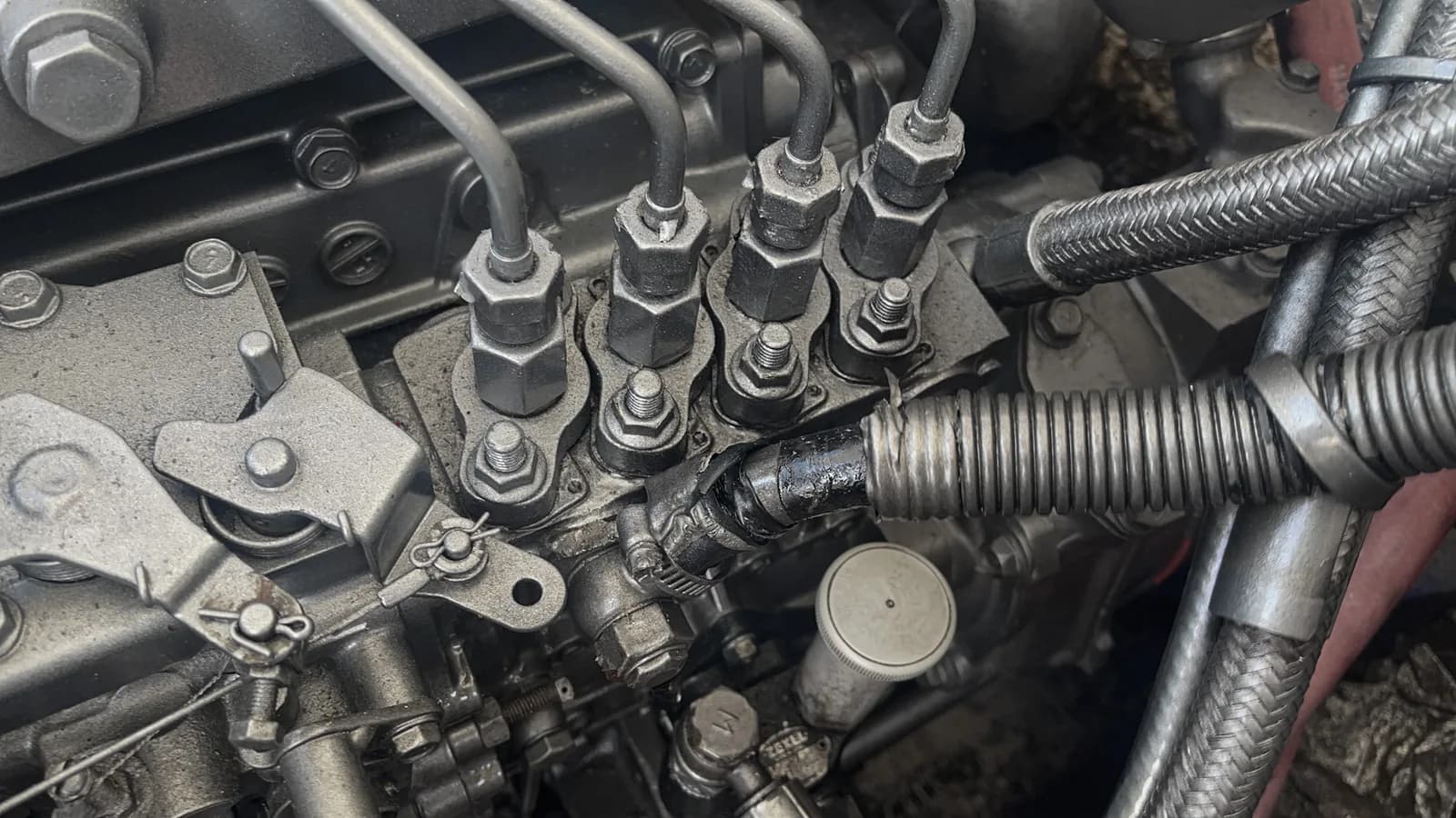 Engine oil being poured into a Yanmar marine diesel during a service